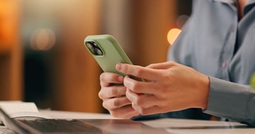 Close up of person's hands holding a cell phone